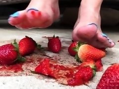 Dominatrix crushing and squeezing strawberries with her feet