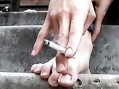 Young punk presents his sexy feet while smoking